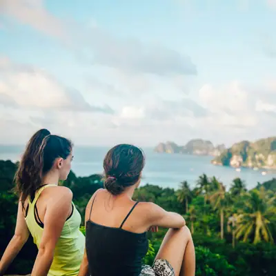 Travellers sitting on a hilltop viewpoint