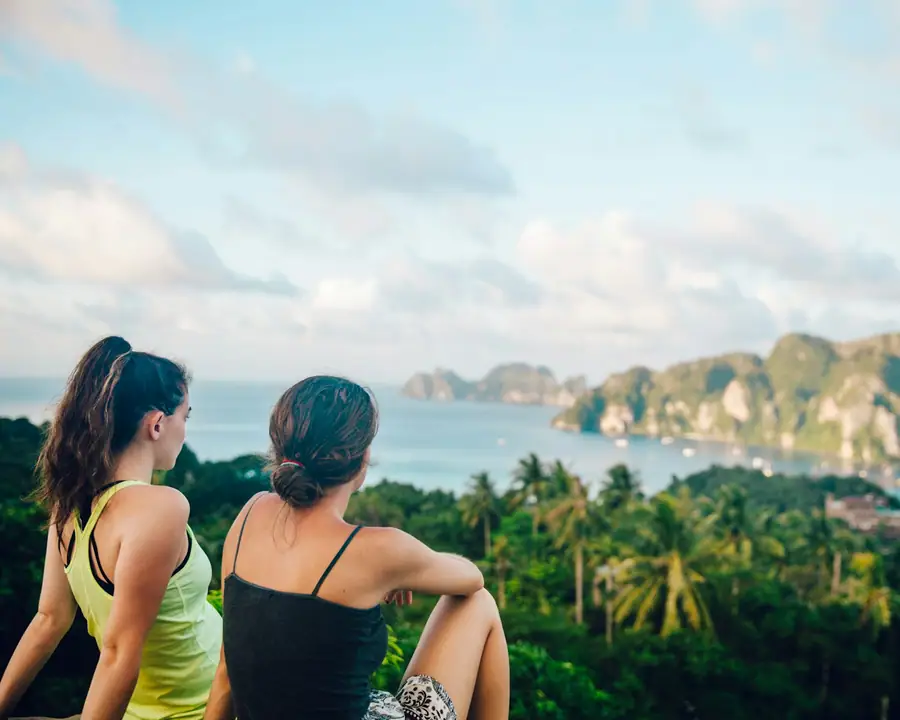 Travellers sitting on a hilltop viewpoint