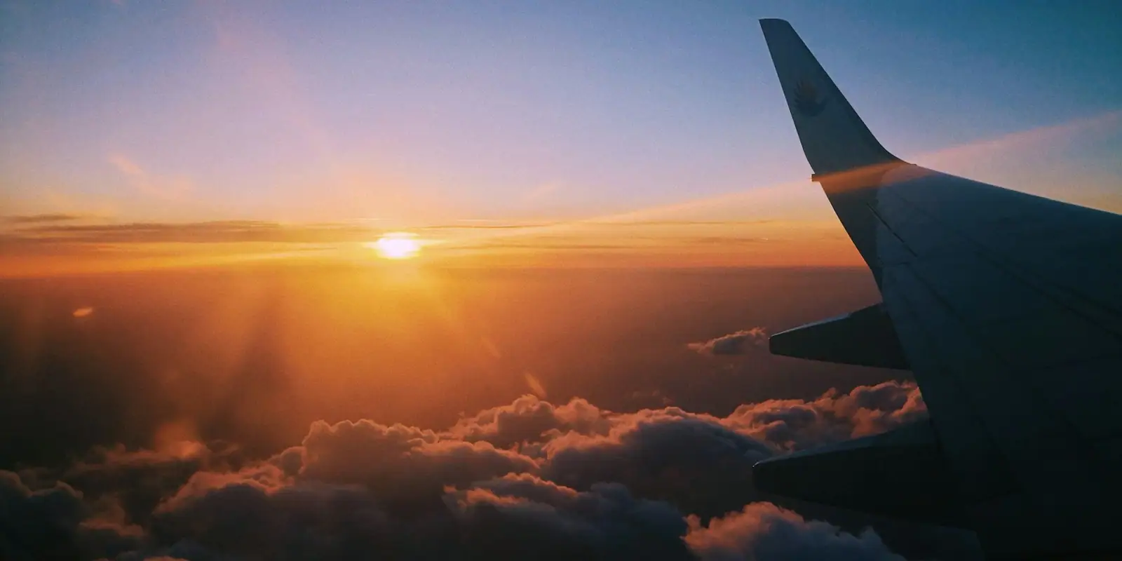 Aircraft above the clouds at golden hour