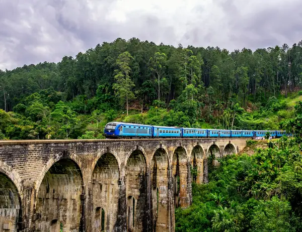 Blue train crossing the Nine Arches Bridge in Ella