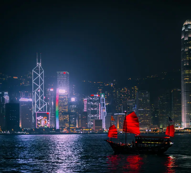 Traditional red-sailed junk boat on Victoria Harbour, Hong Kong