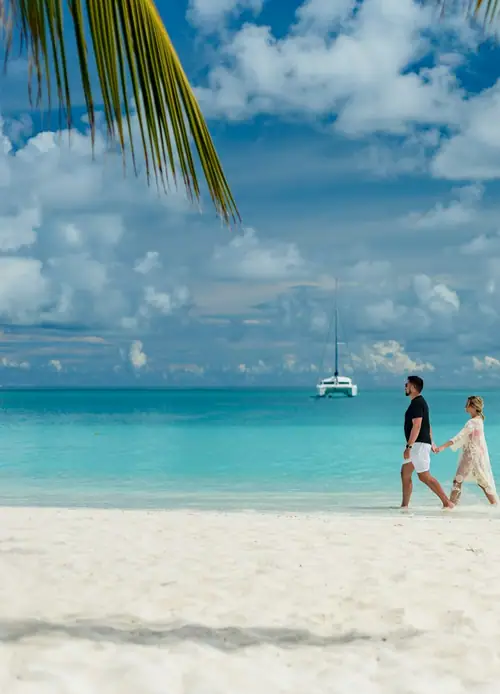Couple walking along a tropical beach